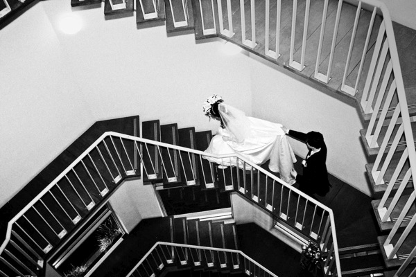 The bride and groom walk up the stairs