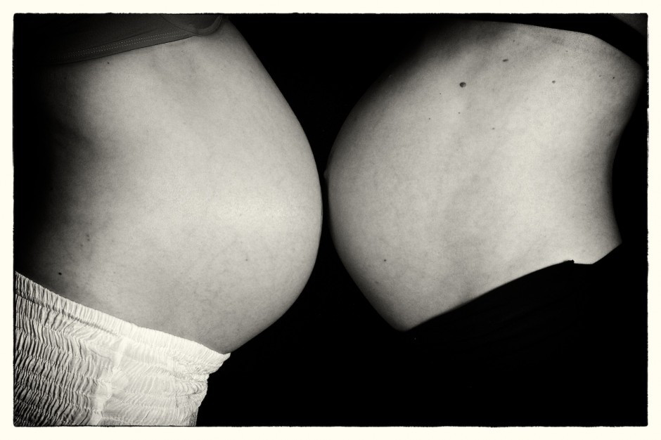 Close up black and white - two baby bellies